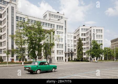 28.04.2019, Kharkiv, , Ukraine - Moskwitsch and Derschprom on Freedom Square in the center of Kharkiv, a building of Constructivism, first Soviet high Stock Photo