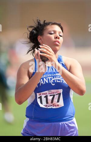 Austin Texas USA, June 6, 2009: Female shot putter prepares to throw the shot during finals at the Texas high school state track and field championships at the University of Texas track stadium. ©Bob Daemmrich Stock Photo