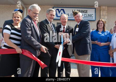 LaGrange Texas USA, September 3, 2009: U.S. Congressman Lloyd Doggett (4th from right) and other dignitaries cut the ribbon at a dedication ceremony for a regional Veteran's Administration outreach health clinic in Fayette County, halfway between Austin and Houston. ©Bob Daemmrich Stock Photo