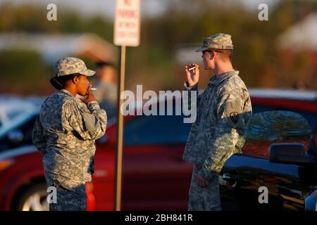 Fort Hood Texas USA: Male and female soldiers in uniform take a cigarette break from their guard duties on the Army base in central Texas. ©Bob Daemmrich Stock Photo