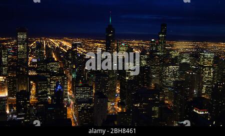 CHICAGO, ILLINOIS, UNITED STATES - DEC 11th, 2015: Aerial view of Chicago downtown at night from John Hancock skyscraper high above Stock Photo