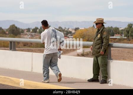 Presidio, Texas USA, December 9 2009: Mexican nationals caught by the U.S. Border Patrol in Arizona are sent across the remote international bridge between Presidio, TX and Ojinaga, Chihuahua, Mexico as part of the ATEP program that attempts to break the cycle of illegal aliens returning back to the United States. ©Bob Daemmrich Stock Photo