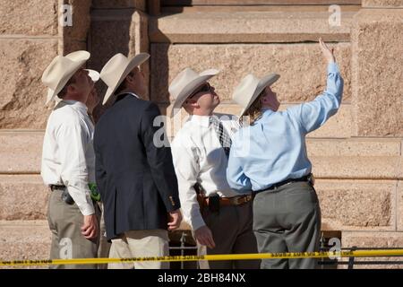 Austin Texas USA, January 21 2010: Texas Rangers examine evidence on the south steps of the Texas Capitol after a man fired several  shots into the air there. The man had earlier entered Texas Lt. Gov. Dan Patrick's Capitol office  ©Bob . Stock Photo