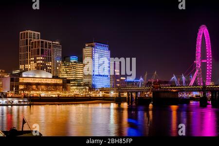 Night view of the South Bank complex including Festival Hall, new apartment blocks and London Eye across the River Thames Stock Photo
