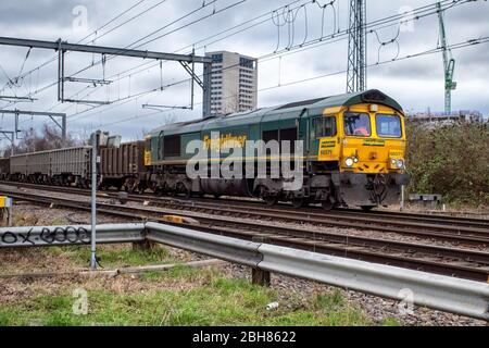 Freightliner Class 66 Diesel Locomotive 66571 pulling wagons on the section of track between Camden Road and Caledonian Road in London, England Stock Photo