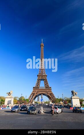 Traffic on Quai Branly in front of the Eiffel Tower and two of the Warrior sculptures, Paris Stock Photo