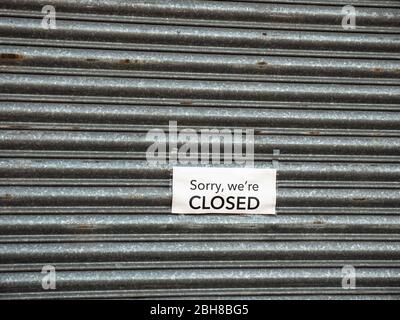 KIRKBY IN ASHFIELD, ENGLAND - APRIL 24: 'Sorry We're Closed' sign on metal shutters of a shop, during Coronavirus pandemic, in the UK. The Precinct, i Stock Photo