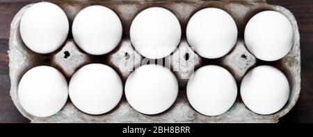 White eggs in a cardboard box close-up. Selective focus. Stock Photo
