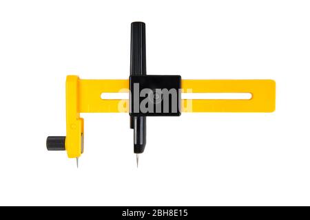 Yellow rotary circle cutter isolated on white. Closeup shot, front view. Stock Photo