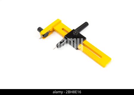Yellow rotary compass cutter isolated on white. Closeup shot, top side view. Stock Photo