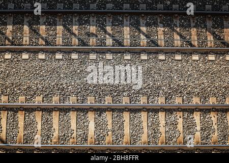 Railroad tracks. From above. A pair of train track lines path with a view from top. Travel concept route. Stock Photo
