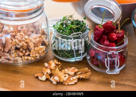 Close up of fresh healthy food ingredients like nuts and chiully pepper - piece of tqable in the kitchen - restaurant and fresh fruits and vegatables Stock Photo