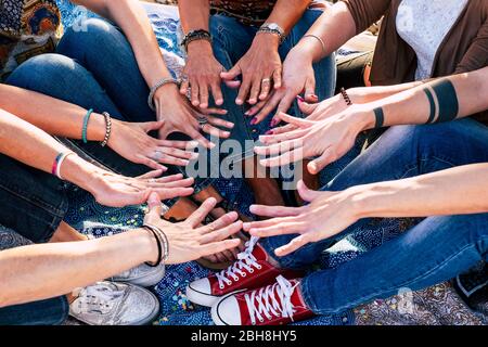 Close up top view of people putting their hands together. Friends with stack of hands showing unity and teamwork - caucasian people in friendship - hipster casual style - diversity ages Stock Photo