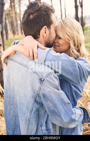 Woman with her eyes closed hugging her boyfriend Stock Photo