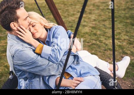 Handsome dark-haired male hugging a pretty woman Stock Photo