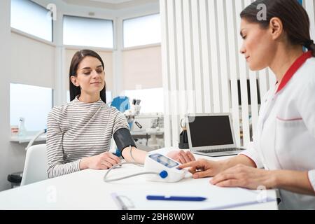 Pleased brunette female person visiting her therapist Stock Photo
