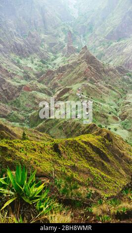 Mountain peaks of Xo-Xo valley in sun light. Local village in the valley. Many agava plants grow on the steep stony slopes. Santa Antao island, Cape Verde. Stock Photo