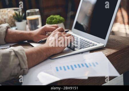 Man typing on his laptop at home Stock Photo