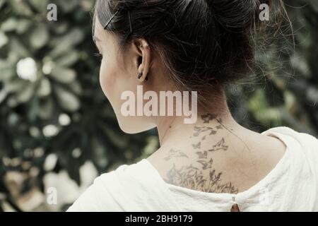 young, pretty Thai girl with tattoo on her neck Stock Photo