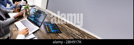 Group Doing Financial Business Analytics On Computer Stock Photo
