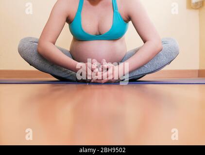 Concentrated Asian Woman on her Yoga Pose Stock Photo