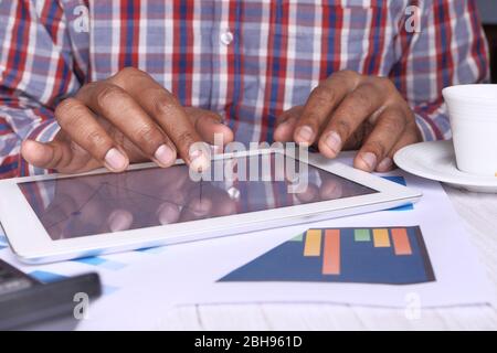 person hand analyzing financial data on digital tablet  Stock Photo
