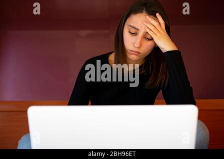 Woman using computer with headache. Stock Photo