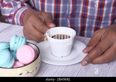 young man with casual dress drinking tea. Stock Photo