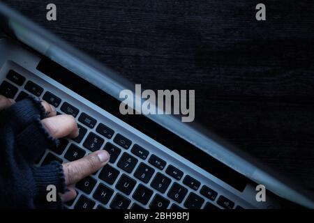 hacker hand stealing data from laptop at night  Stock Photo