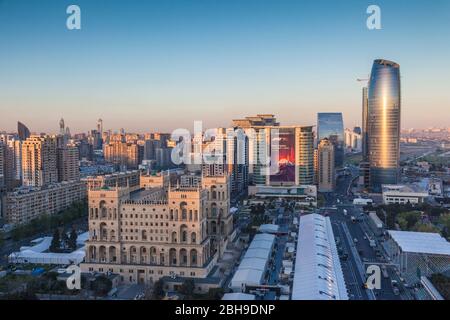 Azerbaijan, Baku, high angle skyline with Dom Soviet Government House, dusk Stock Photo