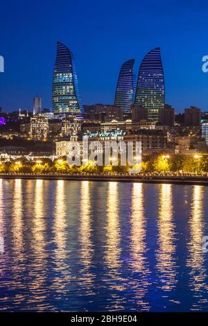 Azerbaijan, Baku, Bulvar Promenade, city skyine with Flame Towers, dusk Stock Photo
