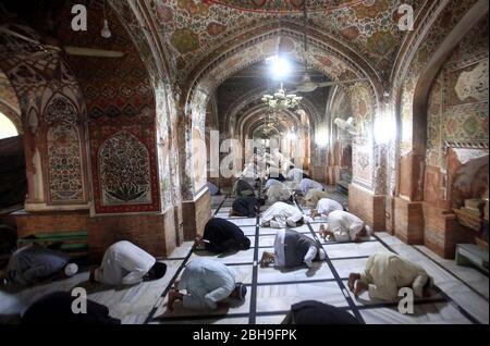 Limited people offer congregational Friday prayers during a complete lockdown from 12 noon to 3:30pm to prevent people from participating in congregational Friday prayers due to increasing in coronavirus cases as preventive measure against the spread of the Coronavirus (COVID-19), at Mahabat Khan Mosque in Peshawar on Friday, April 24, 2020. The number of confirmed COVID-19 cases in Pakistan rose to 11,429 on Friday after new infections were confirmed in the country. Stock Photo