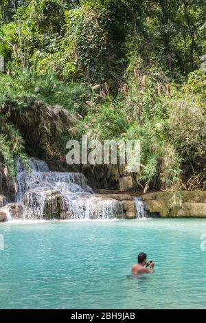 Laos, Luang Prabang, Tat Kuang Si Waterfall, swimmer in turquoise pool, no releases Stock Photo