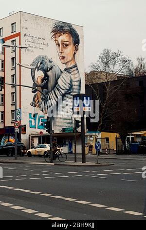 'As Long As You Are Standing, Give a Hand To Those Who Have Fallen' (Herakut/Wes21/Onur, 2018) Graffiti in Berlin Stock Photo