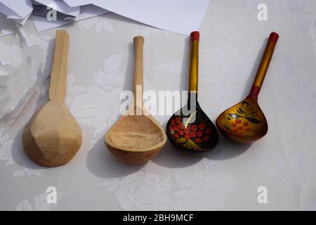 Wooden painted spoons on a white table. National Russian art. Stock Photo