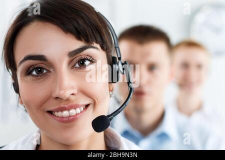 Three call center service operators at work Stock Photo