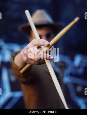 Young man playing drums in an underground environment Stock Photo