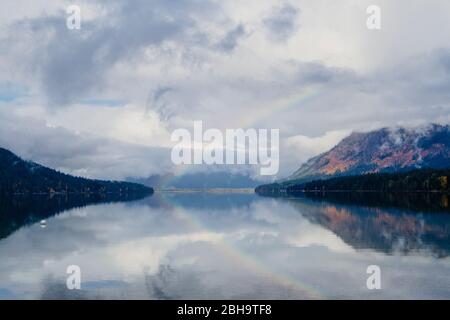 Rainbow over lake and mountain in cloudy day, Lake Wenatchee State Park, Wenatchee, Washington, USA Stock Photo