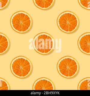 Seamless pattern with real orange slices on pastel background for web design, fabric and tablecloths, flat lay composition Stock Photo