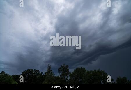 Gloomy clouds over a forest Stock Photo