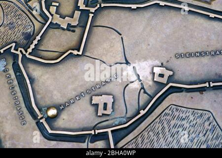 The scale-true historical city plan of the city Kaiserslautern with streets, city walls and historical buildings on a manhole cover. Stock Photo