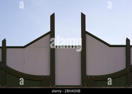 A noise barrier and metal structure on a highway on a bridge in the city. Stock Photo