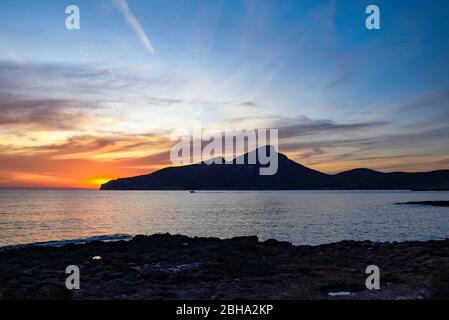 View of the uninhabited rock island Sa Dragonera off the west coast of the Spanish Mediterranean island of Mallorca at sunset Stock Photo