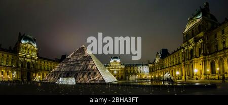 Illuminated Louvre Museum at night, Paris, France Stock Photo