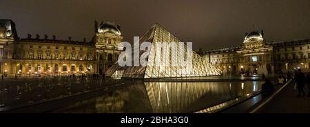 Illuminated Louvre Museum at night, Paris, France Stock Photo