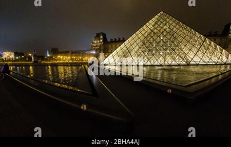 Illuminated Louvre Museum at night, Paris, France Stock Photo