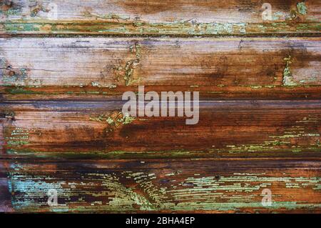 Old wooden board painted in green color with scratches and chips. Stock Photo