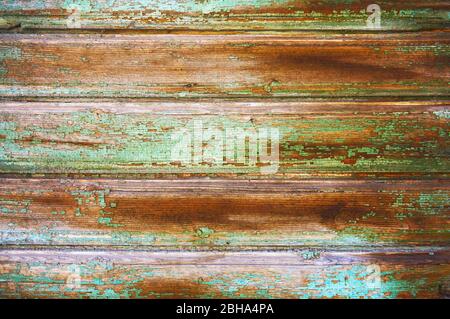 Old wooden board painted in green color with scratches and chips. Stock Photo