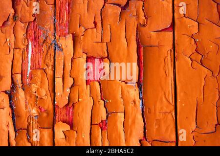 Color on wood chipped and weathered red orange yellow Stock Photo