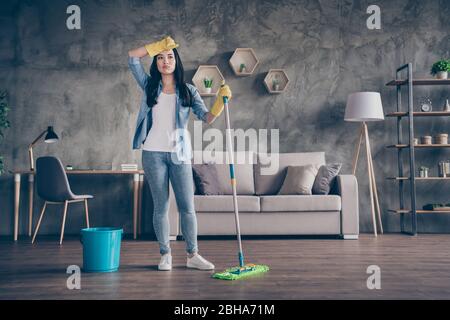 Full length body size view of her she nice attractive busy hardworking tired overwhelmed girl cleansing wooden floor cleanup in modern loft industrial Stock Photo